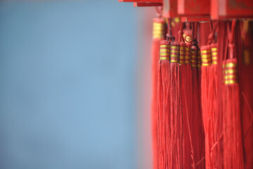 Red fringes under bars with wishes. Taishan mountain temple.