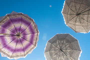 Colorful umbrellas with a blue sky in the background.