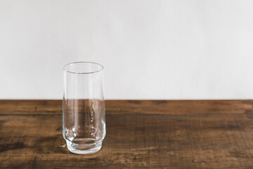 empty glass of water on wooden table. Global crisis, hunger, starvation, thirst concept ideas.