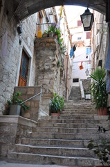 Fototapeta na wymiar Stone stairs up on the streets of the ancient city of Dubrovnik.