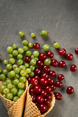 Berry in a waffle cone on a dark gray background.