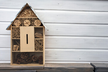 Craftsman built insect hotel decorative wood house with compartments and natural components refuge made to protect and promote ladybugs and butterflies hibernation as useful garden pests