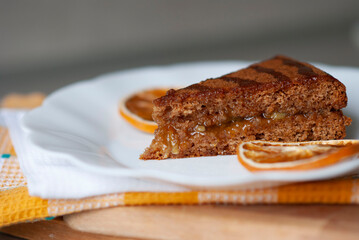 Piece of honey pie with orange jam close up