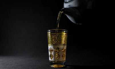 Glass of Arabian tea in the dark