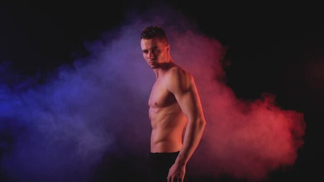 Sexy man in in color smoky background
