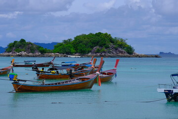 Naklejka na ściany i meble Some typical boats waiting around the island of Ko Lipe to go for their daily business.