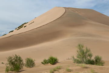 Fototapeta na wymiar Sand dunes known as Singing Dunes in Kazakhstan