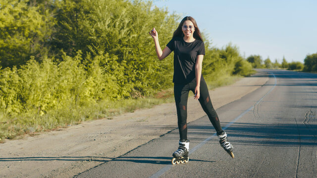 Young nice girl skating in the country. Active leisure concept