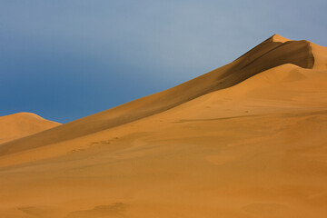 Naklejka na ściany i meble Sand dunes known as Singing Dunes in Kazakhstan