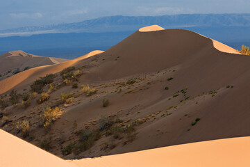 Fototapeta na wymiar Sand dunes known as Singing Dunes in Kazakhstan