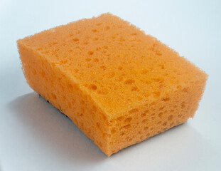 Orange sponge for washing dishes on white background