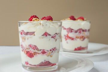 Traditional Scottish dessert, Cranachan with raspberry, whipped cream, whisky and roasted oatmeal close-up.