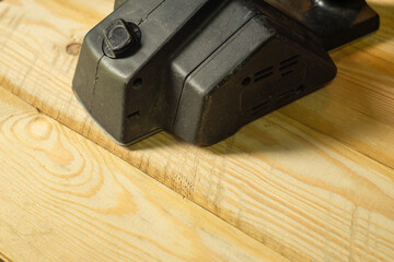 Electric plane black on wooden boards