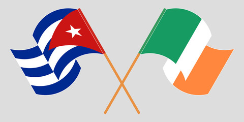 Crossed and waving flags of Cuba and Ireland