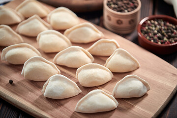 raw dumplings on the wooden board