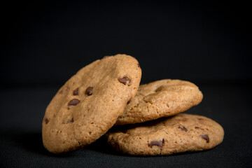 Chocolate chips cookies in a black background