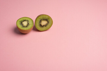 Kiwi halves over pink background