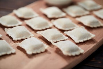 raw dumplings on teh wooden board
