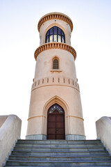 Fototapeta premium Lighthouse at the top of the stairs, in Al Ayjah, Sur, Oman. On the door, there is a sign telling the date it was built: 1996, in the gregorian calendar and 1417, in the arabic calendar.