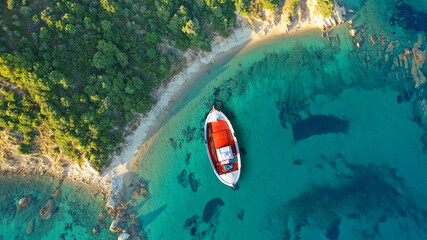 Aerial drone top down photo of traditional fishing boat anchored near small picturesque port of Agnontas, Skopelos, Sporades, Greece © aerial-drone