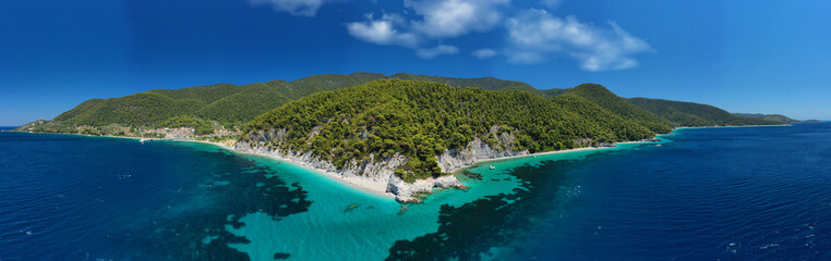 Obraz premium Aerial drone panoramic photo of famous turquoise paradise beach of Hovolo covered with pine trees, Skopelos island, Sporades, Greece