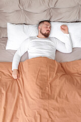 Young man sleeping in bed at home