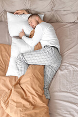 Young man sleeping in bed at home