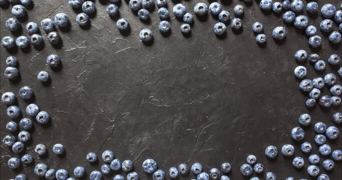 framing from wild berries top view, blueberries on a dark stone background. 4K stop motion animation
