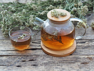Herbal medicinal background.Healthy tea with yarrow flowers on a wooden rustic table. Place for text.