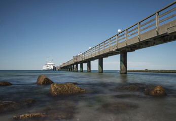 pier with ship on the baltic coast