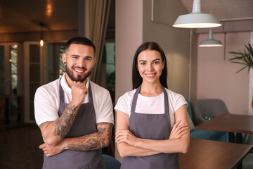 Portrait of young waiters in restaurant