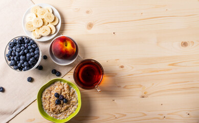blueberries and porridge as morning healthy breakfast concept