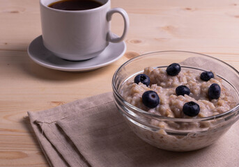 blueberries and porridge as morning healthy breakfast concept