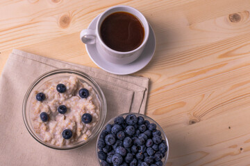 blueberries and porridge as morning healthy breakfast concept