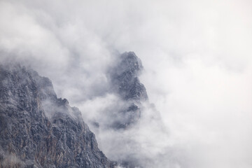 alpine rocks in dense clouds