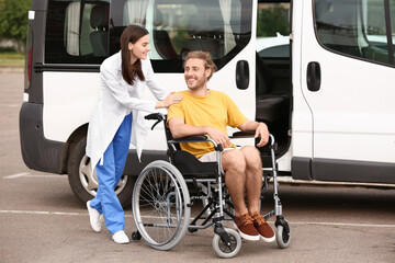 Doctor and handicapped man near car outdoors