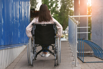Young woman in wheelchair outdoors