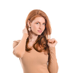 Obraz premium Beautiful young redhead woman on white background