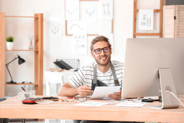 Fototapeta premium Male jewelry designer working in office