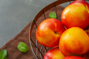 Sweet ripe nectarines in basket, closeup
