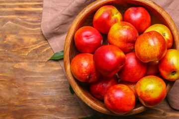 Sweet ripe nectarines in bowl on table