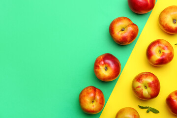 Sweet ripe nectarines on color background