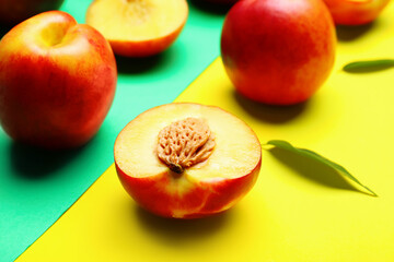 Sweet ripe nectarines on color background