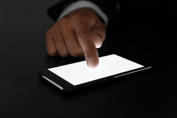 Businessman using mobile phone at table, closeup