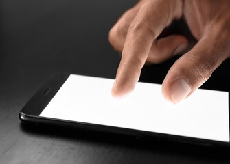 Businessman using mobile phone at table, closeup