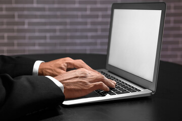 Businessman working on computer at table in dark room