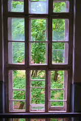 stained glass window with broken glass in an abandoned building