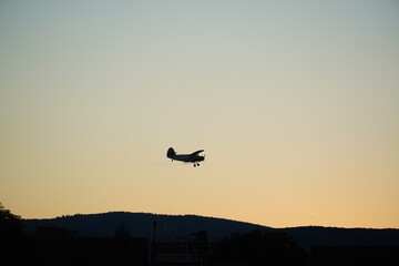 Fototapeta na wymiar Small airplane above a city