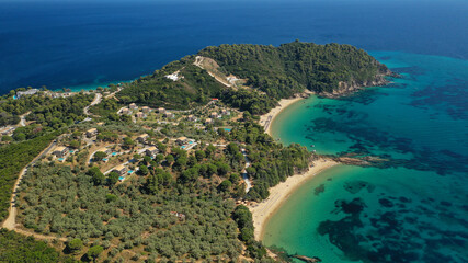 Aerial drone photo of paradise beaches of Banana and small Banana covered with pine trees in beautiful island of Skiathos, Sporades, Greece