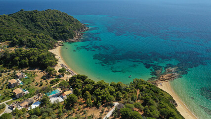 Aerial drone photo of paradise beaches of Banana and small Banana covered with pine trees in beautiful island of Skiathos, Sporades, Greece